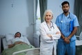 Smiling doctor and standing with arms crossed Royalty Free Stock Photo