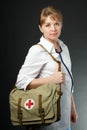 Smiling Doctor with stethoscope and first aid bag