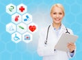 Smiling doctor with tablet pc and medical symbols