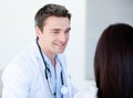 Smiling doctor talking with his patient Royalty Free Stock Photo