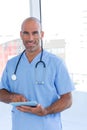 Smiling doctor using tablet computer Royalty Free Stock Photo