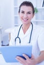 Smiling doctor using tablet computer Royalty Free Stock Photo