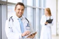 Smiling doctor waiting for his team while standing upright Royalty Free Stock Photo