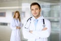 Smiling doctor waiting for his team while standing upright Royalty Free Stock Photo