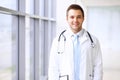 Smiling doctor waiting for his team while standing upright Royalty Free Stock Photo