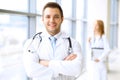 Smiling doctor waiting for his team while standing upright Royalty Free Stock Photo