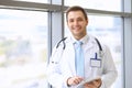 Smiling doctor waiting for his team while standing upright Royalty Free Stock Photo