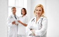 Smiling doctor in white coat at hospital