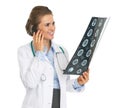 Smiling doctor woman with fluorography talking cell phone Royalty Free Stock Photo