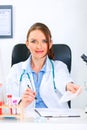 Smiling doctor woman giving medical prescription