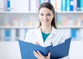 Smiling doctor writing on a clipboard Royalty Free Stock Photo