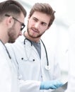 Smiling doctors discussing x-ray with colleagues