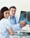 Smiling doctors examining an x-ray Royalty Free Stock Photo