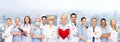 Smiling doctors and nurses with red heart