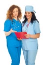 Smiling doctors women reading clipboard