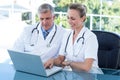 Smiling doctors working together on laptop Royalty Free Stock Photo