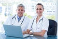 Smiling doctors working together on laptop Royalty Free Stock Photo