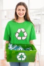 Smiling eco-minded brunette holding recycling box Royalty Free Stock Photo