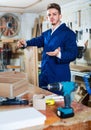 Man measuring boards for furniture at workshop