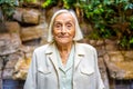 Smiling elder woman in the garden of a nursing home