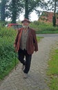 An smiling elderly gentleman making his daily walk