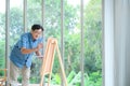 Smiling elderly man painting a vacation at home. Royalty Free Stock Photo