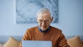 smiling elderly man working on laptop Royalty Free Stock Photo