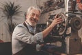 Smiling elderly man in a workshop Royalty Free Stock Photo
