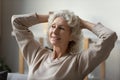 Happy 60s mature woman feel optimistic relaxing at home Royalty Free Stock Photo