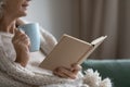 Smiling elderly senior woman drinking tea, reading paper book. Royalty Free Stock Photo