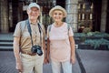 Smiling elderly tourists looking in front of them