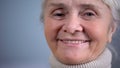 Smiling elderly woman close-up, social security, care in old age, positive mood