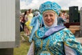 Smiling elderly woman in Russian folk costume at the Karatag music festival. Royalty Free Stock Photo