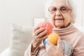 Smiling eldery woman holding colorful laces balls Royalty Free Stock Photo