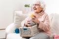 Smiling eldery woman holding colorful laces balls