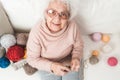 Smiling eldery woman knitting