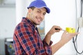 Smiling electrician wiring house Royalty Free Stock Photo