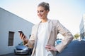 Smiling elegant businesswoman looking at her smartphone Royalty Free Stock Photo