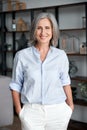 Smiling elegant confident middle aged woman standing in office, portrait. Royalty Free Stock Photo