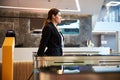 Smiling elegant lady passing electronic turnstile at airport