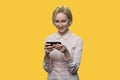 Smiling elegant lady is typing on the smartphone. Royalty Free Stock Photo