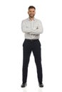 Smiling elegant man is standing with arms crossed. Front view. Isolated Royalty Free Stock Photo