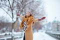 Smiling elegant woman in brown hat and scarf rejoicing Royalty Free Stock Photo