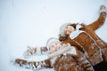smiling elegant mother and child making snow angel