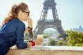 Traveller woman with coffee cup eating baguette having excursion Royalty Free Stock Photo