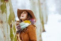 Smiling elegant woman outside in city park in winter Royalty Free Stock Photo