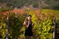 Smiling elegant woman in nature.Joy and happiness.Serene female in wine grape field in sunset.Wine growing field.Agricultural tour Royalty Free Stock Photo