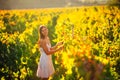 Smiling elegant woman in nature. Joy and happiness. Serene female in wine grape field in sunset. Wine growing field. Agricultural