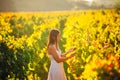 Smiling elegant woman in nature.Joy and happiness.Serene female in wine grape field in sunset.Wine growing field.Agricultural tour