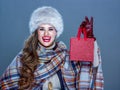 Smiling elegant woman showing small red shopping bag Royalty Free Stock Photo